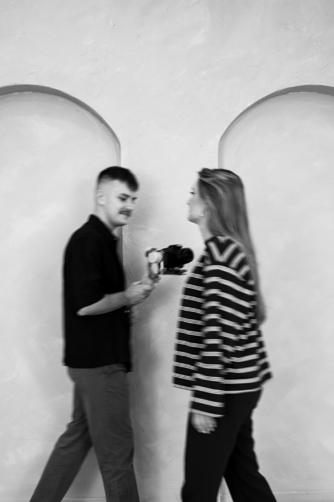 Natalia i Krzysztof z gimbalem podczas sesji, czarno-białe zdjęcie w ruchu